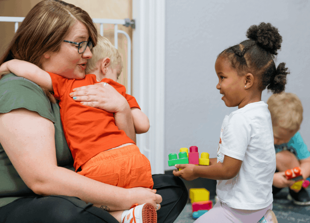 Woman hugging child.